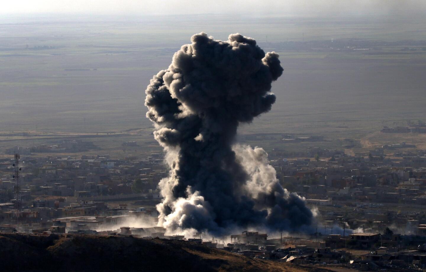 Heavy smoke billows during an operation by Iraqi Kurdish forces backed by US-led strikes in the northern Iraqi town of Sinjar to retake the town from the Islamic State group and cut a key supply line to Syria.