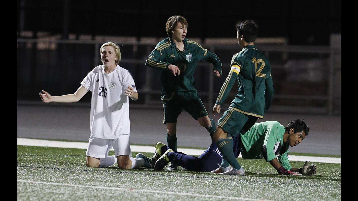 Edison's Zac Ingals (12) congratulates Dustin Vorhees after he scored a goal against Newport Harbor during a Sunset League game on Monday, January 29.