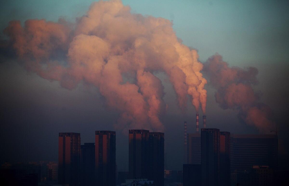 A thermal power plant discharges heavy smog into the air in Changchun, in northeast China's Jilin province, in 2013.
