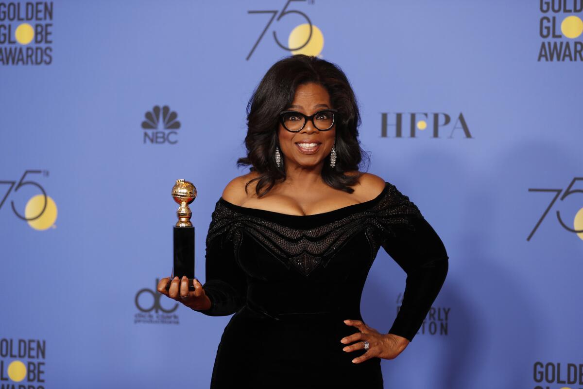 Oprah Winfrey in 2018, holding a Golden Globe award