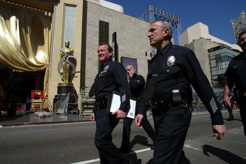 Then-LAPD Police Chief William Bratton, right, takes a tour down Hollywood Boulevard to check on security plans for the 75th Academy Awards. At left is then-Assistant Chief Jim McDonnell.