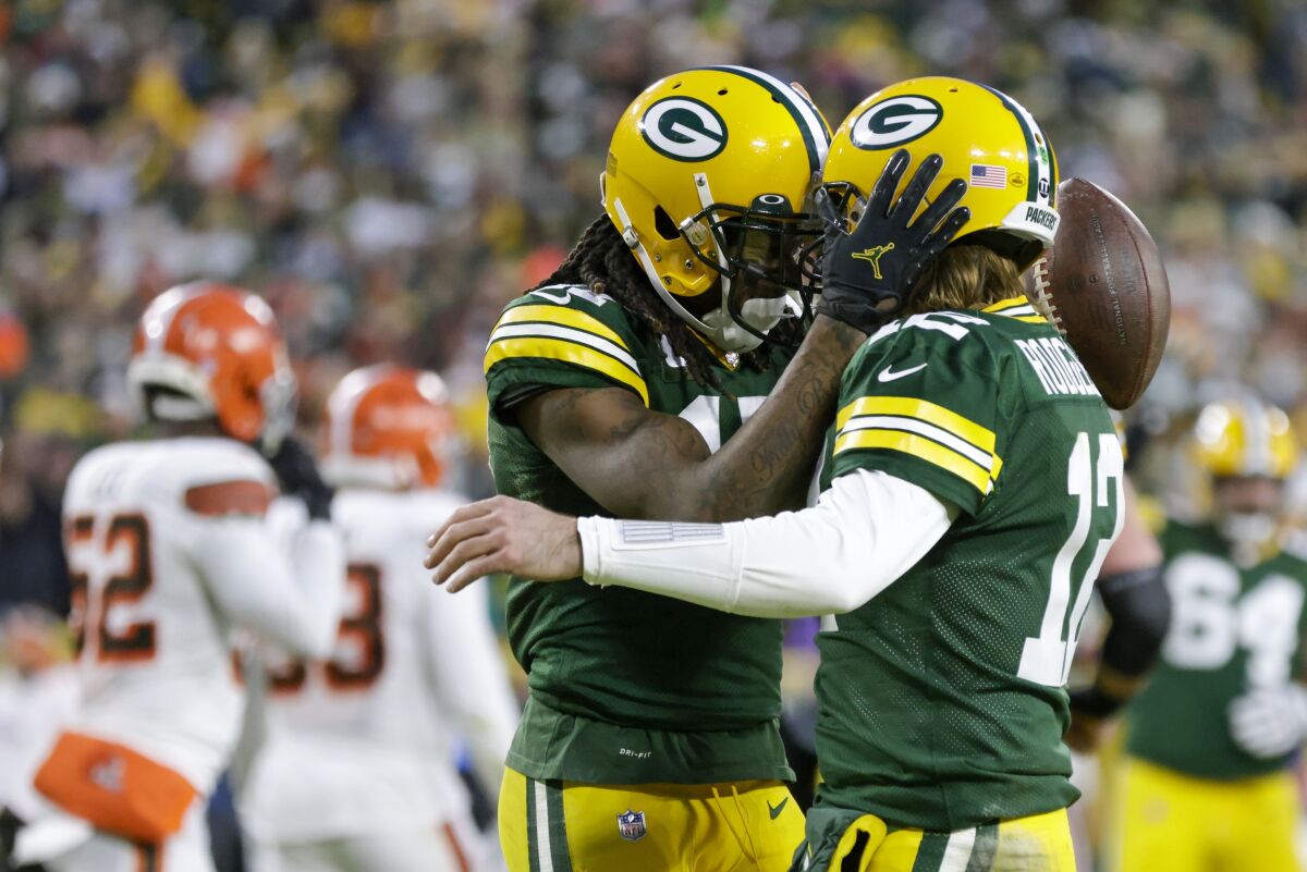 FILE - Green Bay Packers' Davante Adams, left, celebrates his touchdown reception with Aaron Rodgers during the first half of an NFL football game against the Cleveland Browns Saturday, Dec. 25, 2021, in Green Bay, Wis. Until this season, Green Bay Packers quarterback Aaron Rodgers always referred to Hall of Fame cornerback Charles Woodson as his greatest teammate ever. After a Christmas Day victory over the Cleveland Browns, Rodgers called Adams the “most dominant player I’ve played with.” (AP Photo/Matt Ludtke, File)