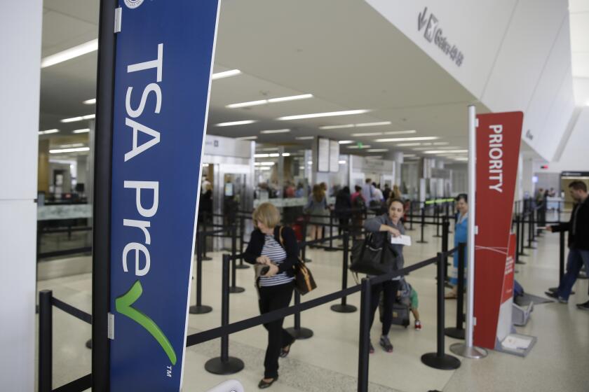 FILE- In this June 29, 2016, file photo passengers make their way through a TSA Precheck security line inside Terminal 2 of San Francisco International Airport in San Francisco. If time is money, find out whether your credit card will reimburse you the application fee for TSA PreCheck or Global Entry programs. These programs can offer faster clearance through airport screening, and some cards offer application credits of up to $100. (AP Photo/Eric Risberg, File)