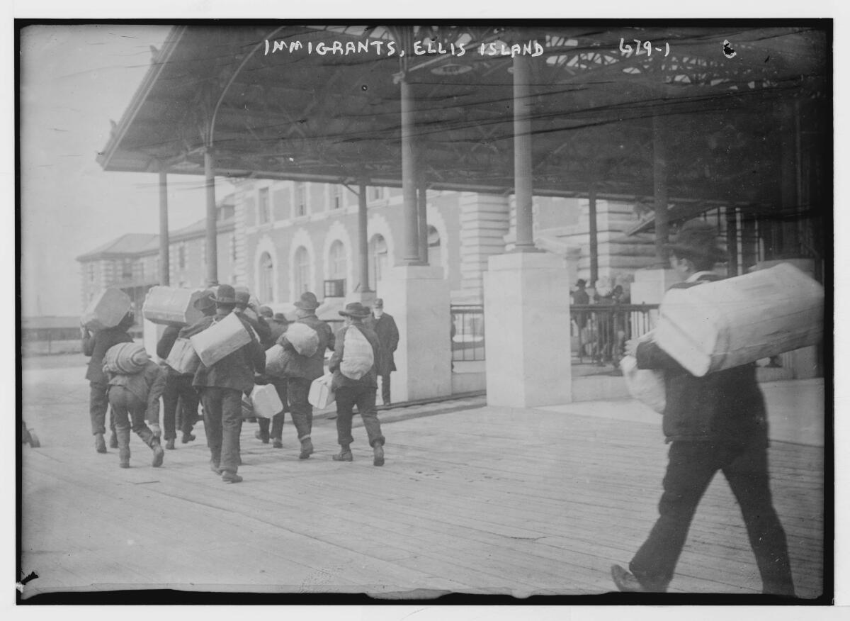 A black-and-white photograph of immigrants on Ellis Island