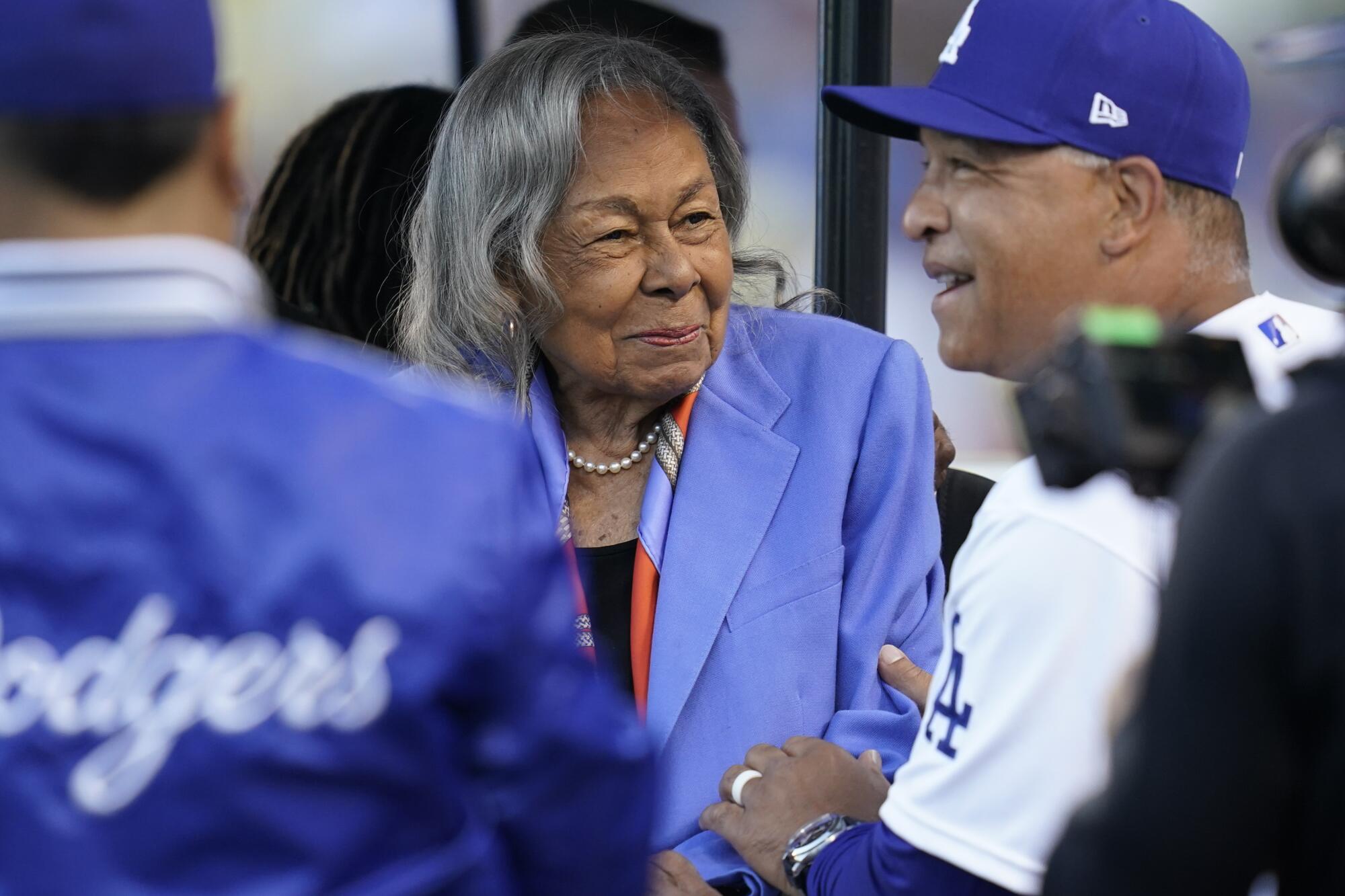 Rachel Robinson, wife of Jackie Robinson, speaks with Dodgers manager Dave Roberts before Friday's game at Dodger Stadium.