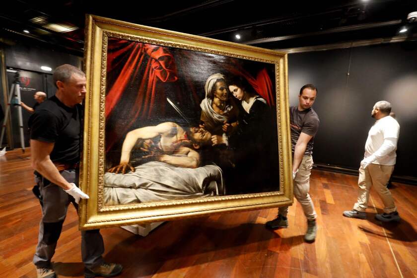TOPSHOT - Workers carry a painting believed by some experts to be Caravaggio's "Judith Beheading Holofernes" for its public presentation at the Drouot auction house in Paris on June 14, 2019 before it goes under the hammer on June 27 in Toulouse, the city where it was discovered five years ago. (Photo by FRANCOIS GUILLOT / AFP)FRANCOIS GUILLOT/AFP/Getty Images ** OUTS - ELSENT, FPG, CM - OUTS * NM, PH, VA if sourced by CT, LA or MoD **