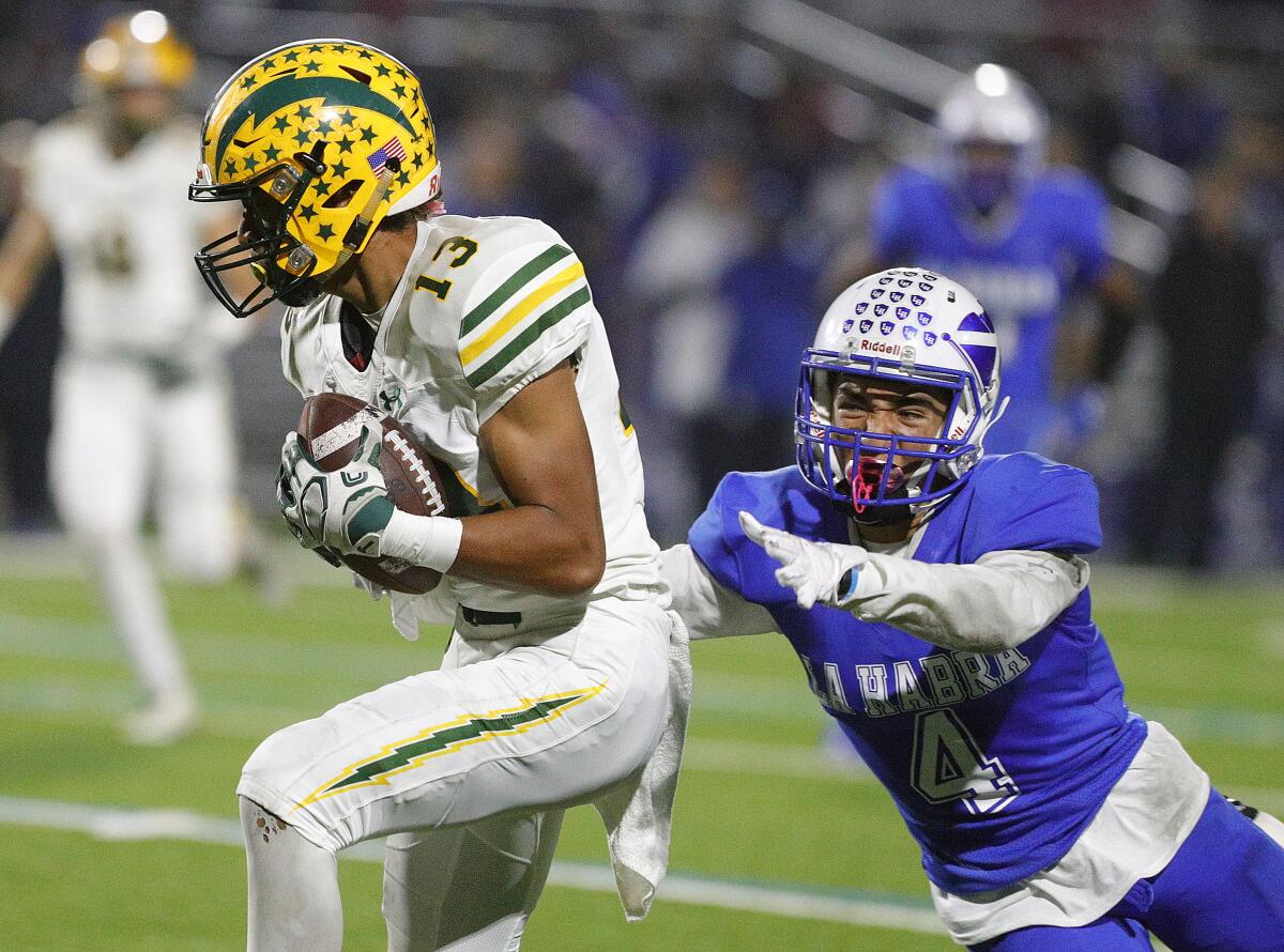 Edison's Cole Koffler catches a pass and beats La Habra's Noel Vallejo for a 56-yard touchdown in the quarterfinals of the CIF Southern Section Division 3 playoffs on Friday.