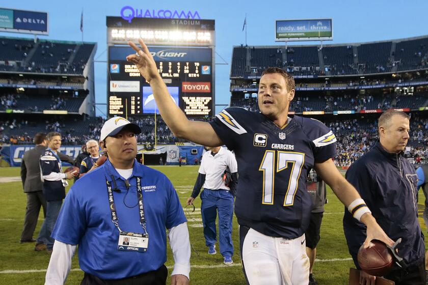 Chargers quarterback Philip Rivers waves to fans as he leaves the field after leading his team to a 30-14 win over the Dolphins at Qualcomm Stadium.