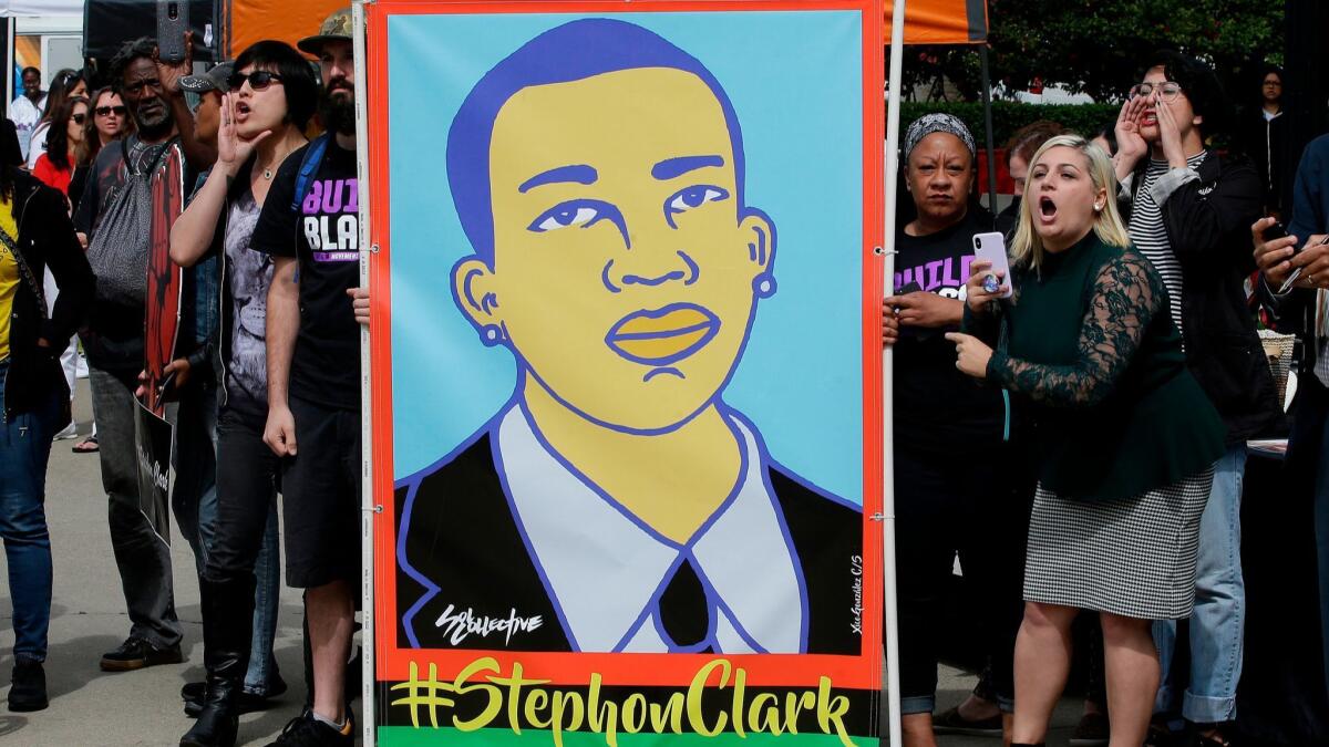 Protesters display an image of Stephon Clark in Sacramento on April 9.