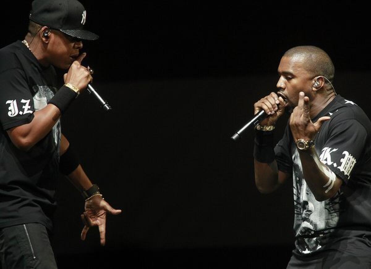 Jay-Z, left, and Kanye West, right, on stage at Staples Center December 11, 2011 for their 'Watch The Throne' tour in Los Angeles.