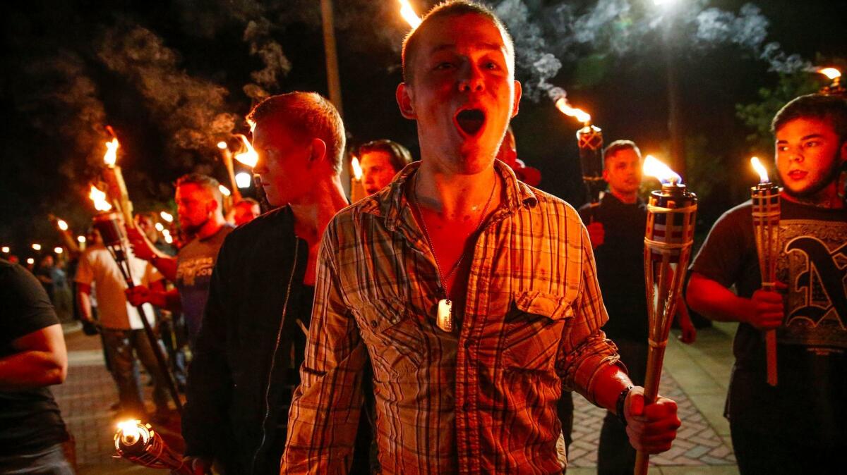 White nationalist groups march with torches through the University of Virginia campus in Charlottesville, Va., on Friday.