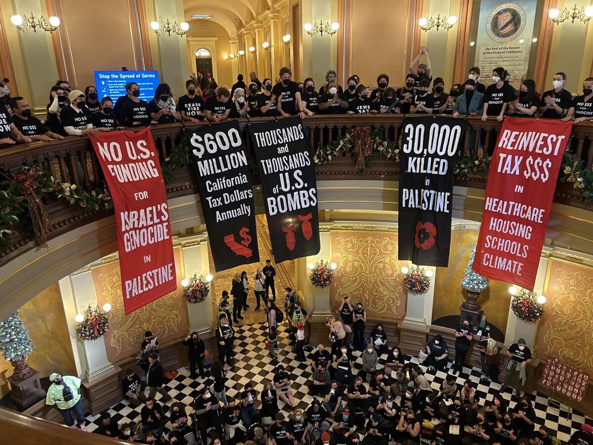 Activists calling for a cease-fire in Gaza crowded the California Capitol and hung banners from the rotunda balcony railing