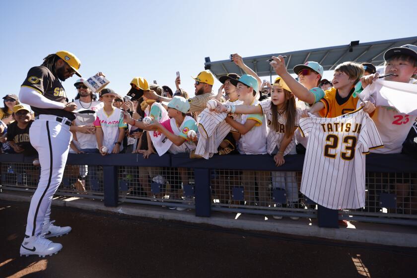 PEORIA, AZ - February 22: San Diego Padres' Fernando Tatis Jr. signs autographs for fans before a spring training game against the Los Angeles Dodgers in Peoria, AZ on February 22, 2024. (K.C. Alfred / The San Diego Union-Tribune)