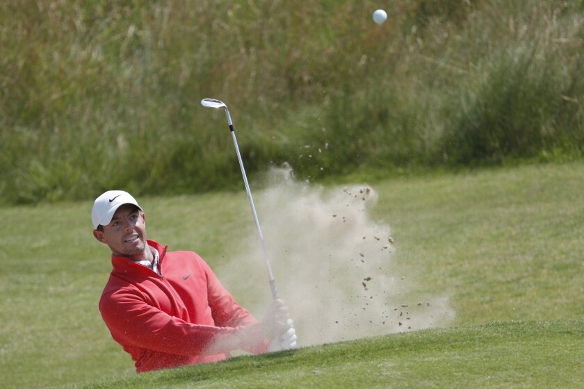 Northern Ireland's Rory McIlroy play out of a bunker on the 6th green during a practice round for the British Open Golf Championship at Royal St George's golf course Sandwich, England, Tuesday, July 13, 2021. The Open starts Thursday, July, 15. (AP Photo/Peter Morrison)