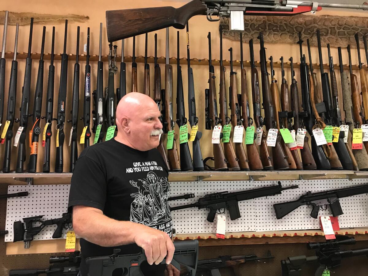 Sam Scarmardo, head of the Mohave County GOP, at his gun store in Lake Havasu City, Ariz.