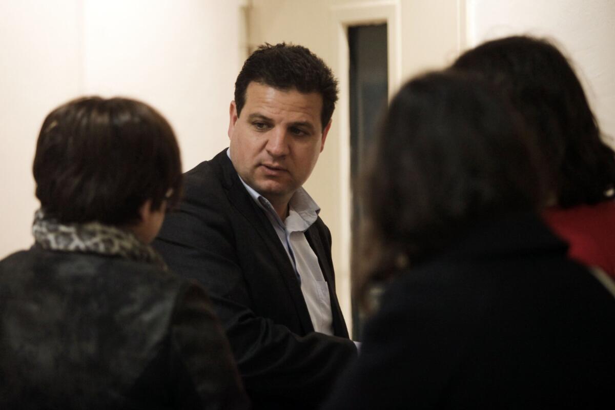 Ayman Odeh, head of the Joint List, an alliance of four small Arab-backed parties running in the upcoming Israeli elections, talks to voters March 2 in Jerusalem.