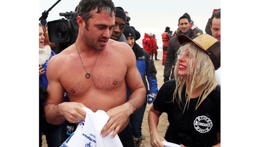 Actor Taylor Kinney and fiancee Lady Gaga were among those dipping into freezing Lake Michigan on Sunday in Chicago. The 15th annual Polar Plunge raised money for the local chapter of Special Olympics.