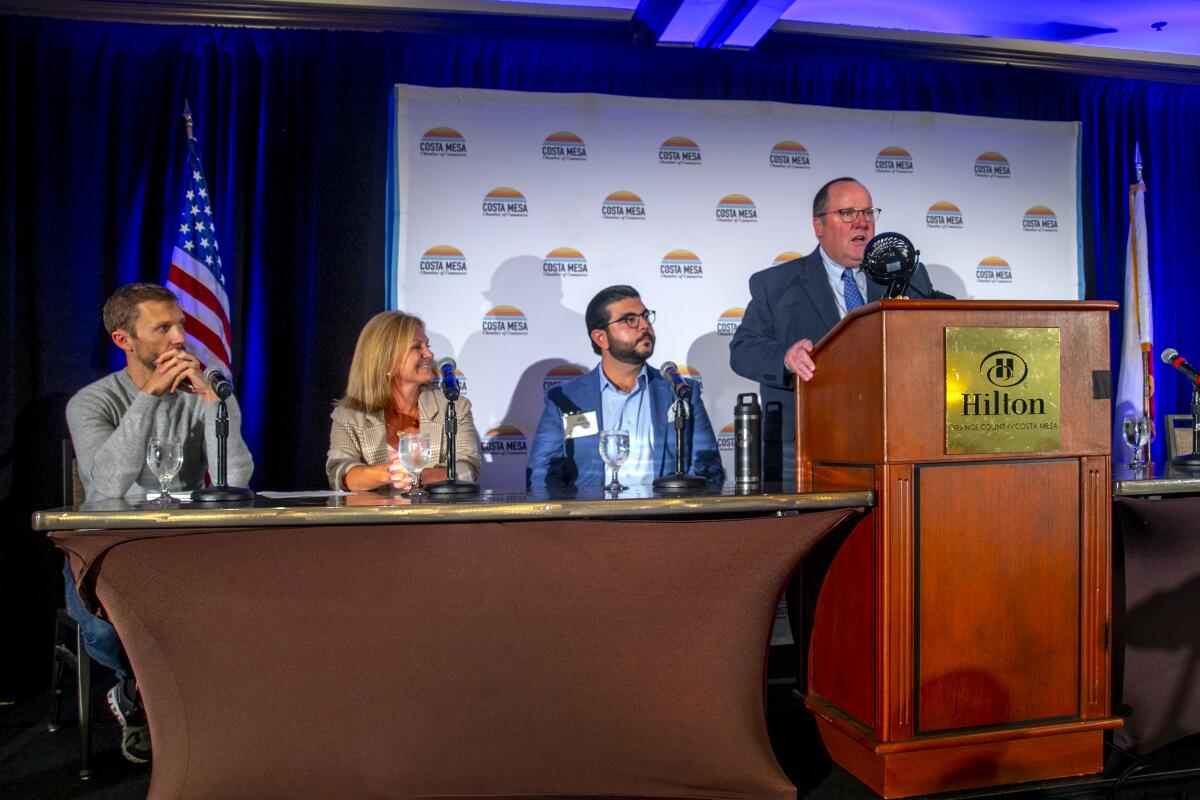 Costa Mesa Mayor John Stephens introduces panel discussion members Matt Grimm, Molly Unger and Joshua Gonzalez.