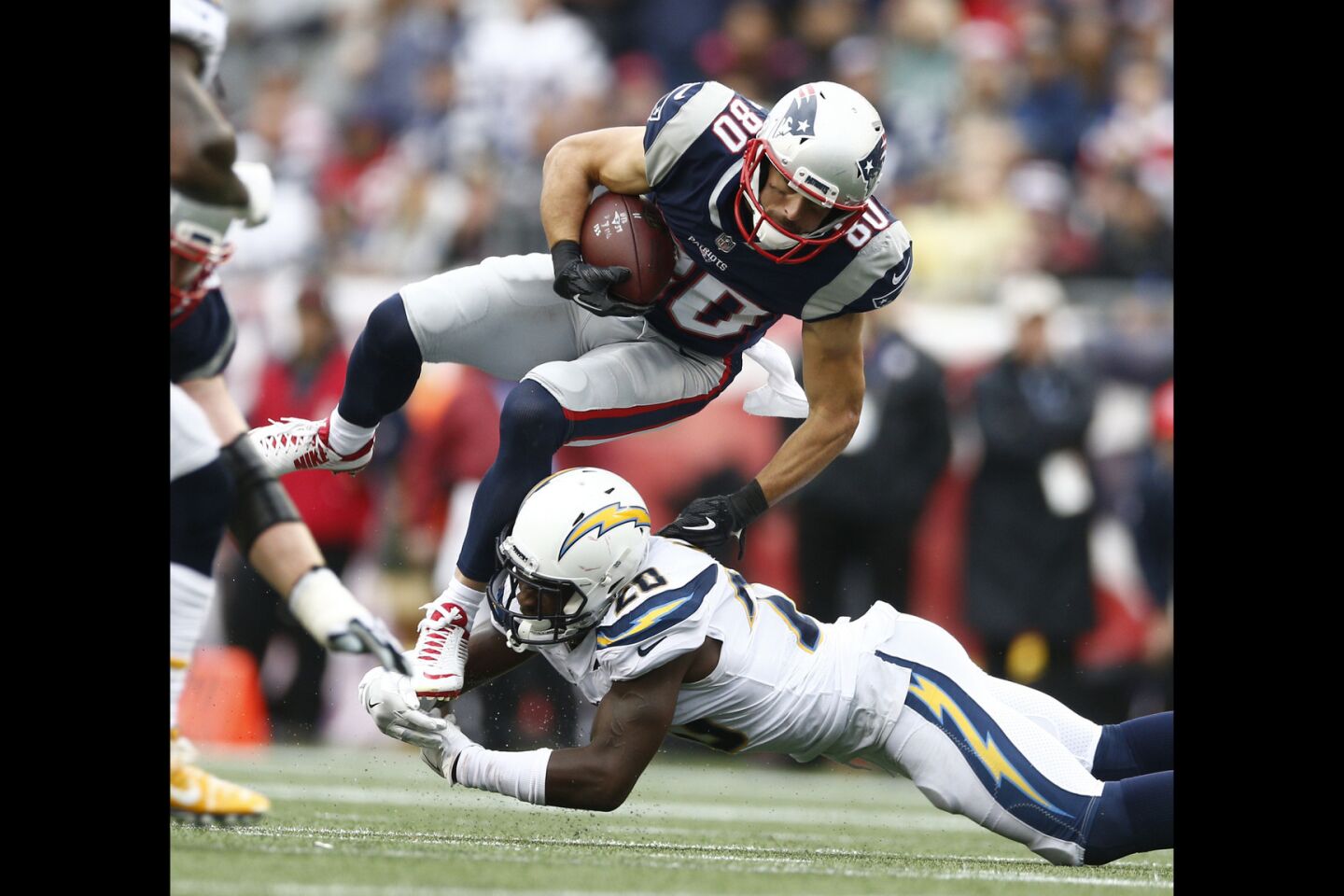New England Patriots wide receiver Danny Amendola is tripped up by Los Angeles Chargers defensive back Desmond King during the second half.