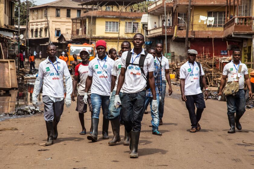 A team of health workers searches for people suffering from Ebola during an education drive in Freetown, Sierra Leone, in March.