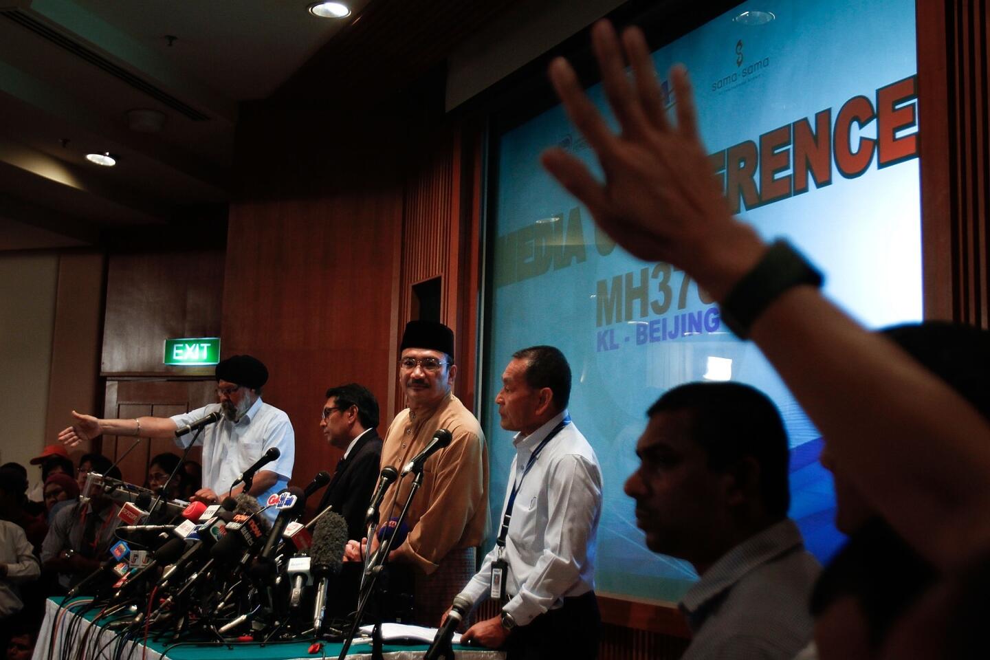 Minister of Transport Hishamuddin Hussein (C), Director General of the Department of Civil Aviation (DCA) Azharuddin Abdul Rahman (L) and MAS Group CEO Ahmad Jauhari Yahya (R) react to a question from the floor during a press conference as the search for missing Malaysian airline MH370 expands.