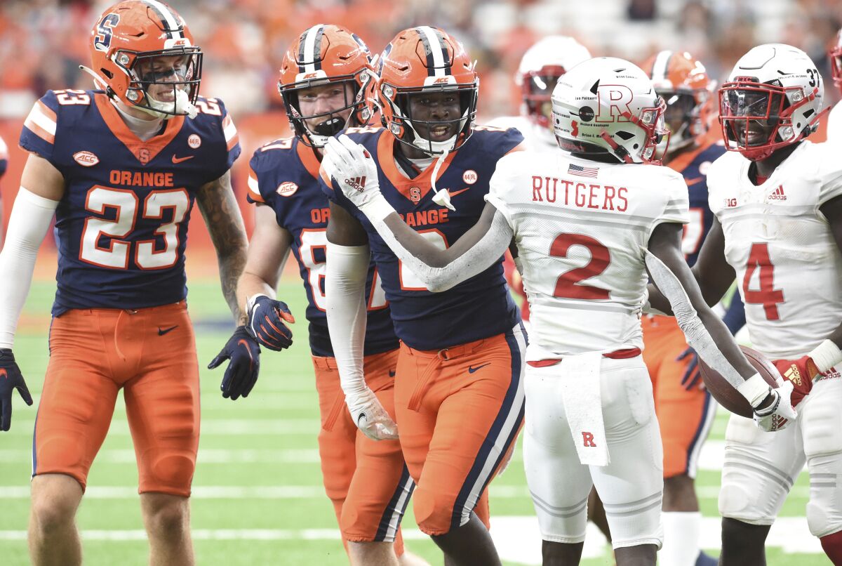 Syracuse defensive end Marlowe Wax gets in the face of Rutgers wide receiver Aron Cruickshank (2) after a tackle in the second half of an NCAA college football game, Saturday, Sept. 11, 2021, at the Carrier Dome in Syracuse, N.Y. (Dennis Nett/The Post-Standard via AP)
