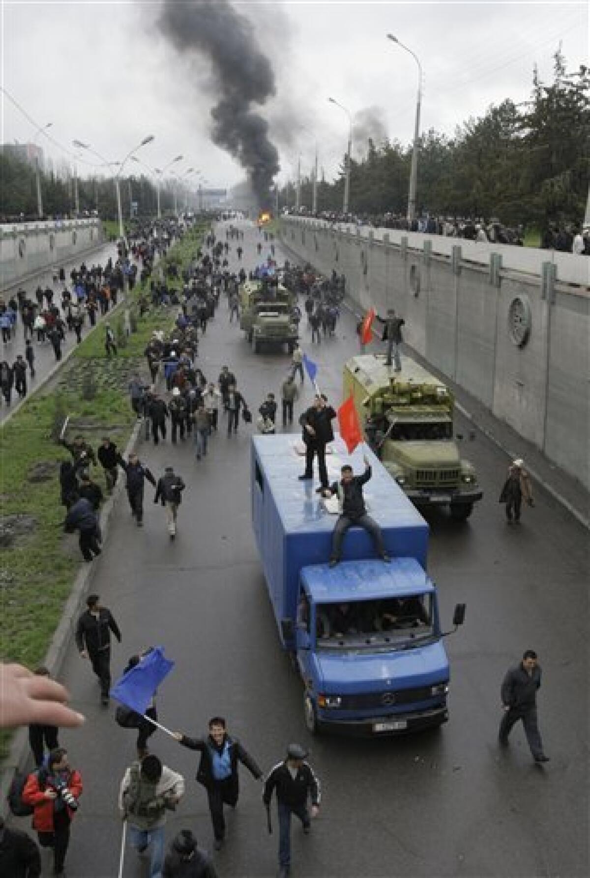 Kyrgyz protesters waving the national flag, ride on a truck in Bishkek, Kyrgyzstan, Wednesday, April 7, 2010. Police in Kyrgyzstan opened fire on thousands of angry protesters who tried to seize the main government building amid rioting in the capital as protests spread across the Central Asian nation. (AP Photo/Ivan Sekretarev)