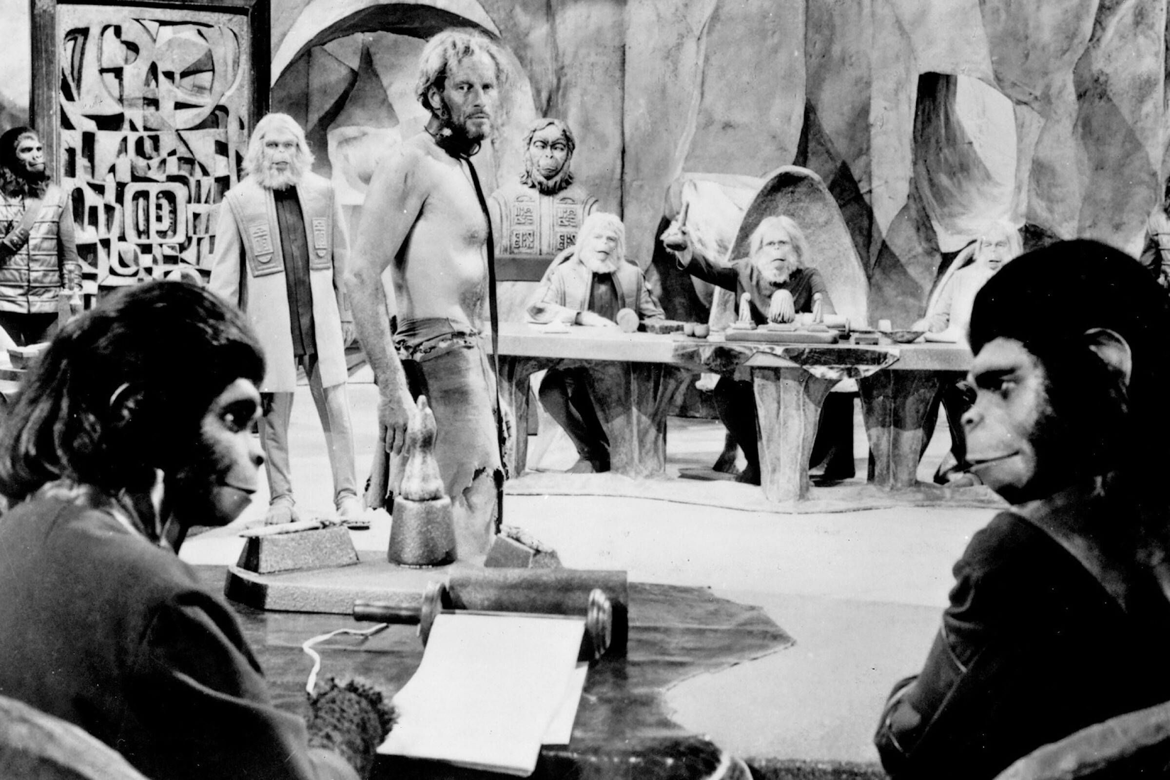 Kim Hunter, left foreground, and Roddy McDowall, as chimpanzee scientists, with human Charlton Heston, center in the 1968’s “Planet of the Apes.” 