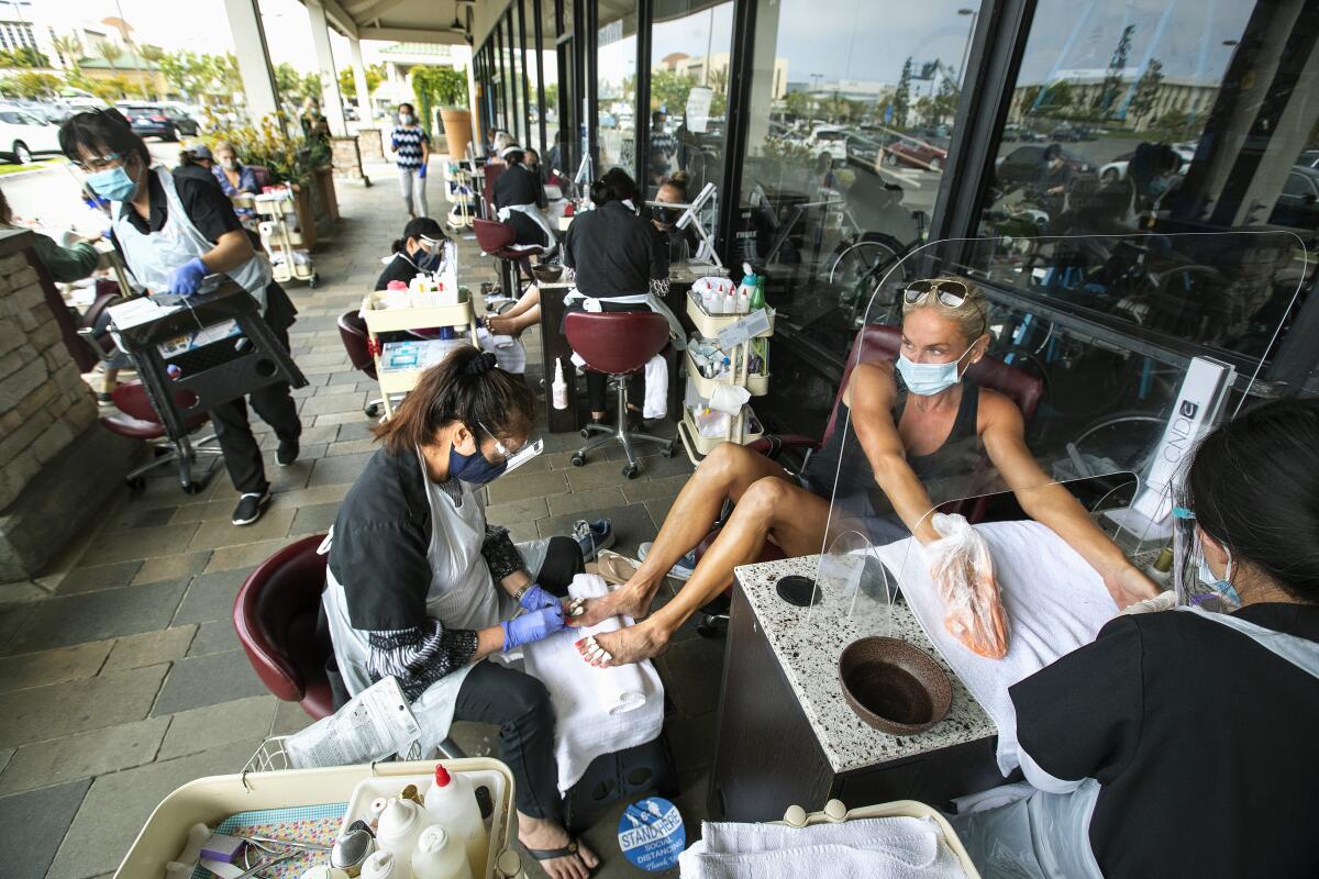 RonAnn Myers of Hawthorne gets a pedicure from Hue Thi Nguyen and manicure from Tina Nguyen at Posh Nails in Manhattan Beach.