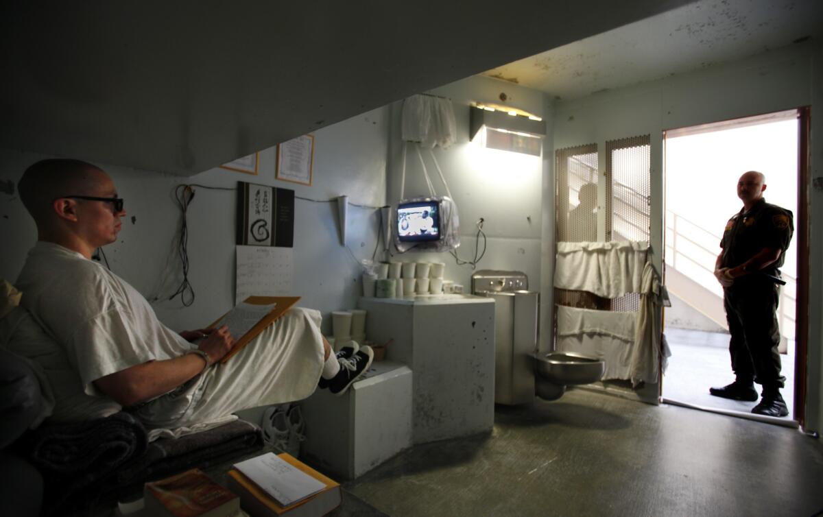 A guard watches over inmate Javier Zubiate in the isolation unit at Pelican Bay State Prison in Crescent City, Calif., in October 2012.