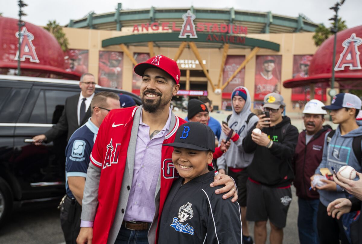 Newly signed Angels third baseman Anthony Rendon poses for a photo with fan Jesse Olivan.
