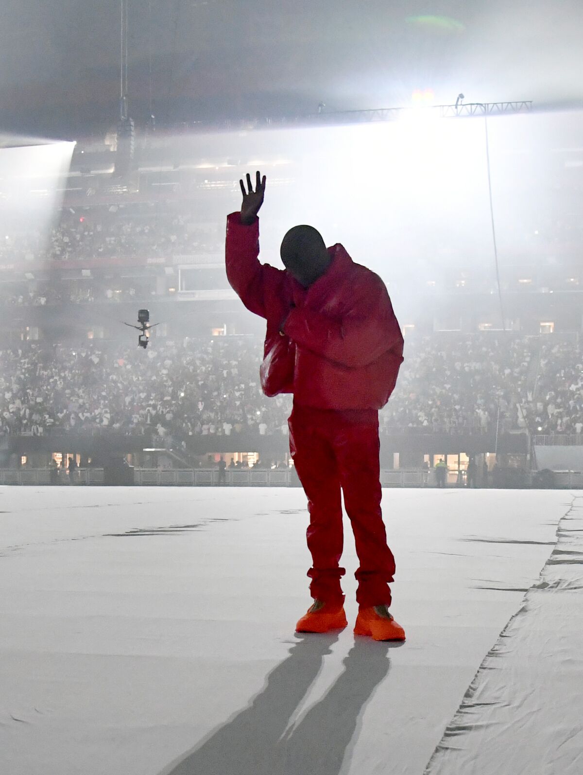 Kanye West in red jacket and pants
