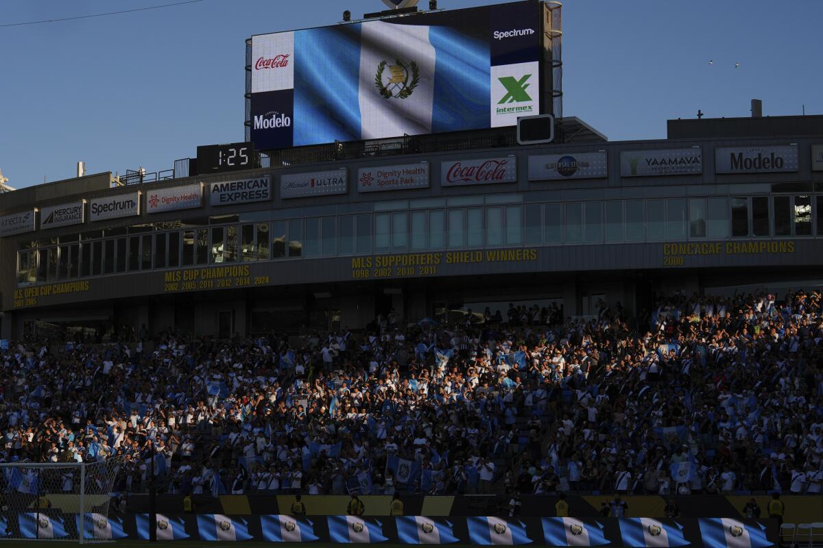 Fans listen to the the national anthem of Guat