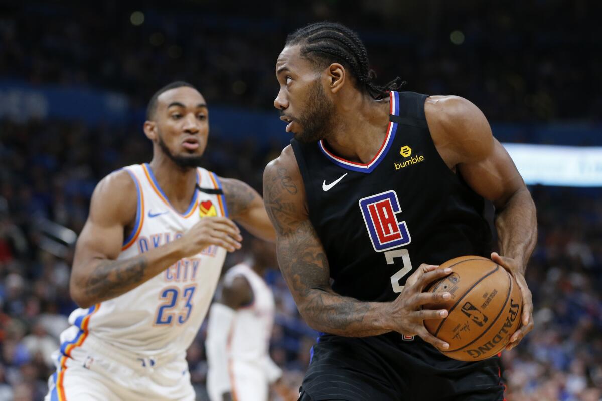 Kawhi Leonard looks for an opening against the Thunder's Terrance Ferguson during the first half of a game March 3 at Chesapeake Energy Arena.