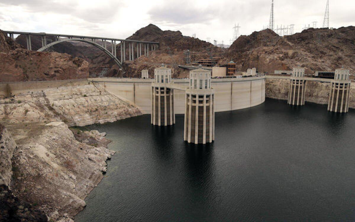 The high water mark for Lake Mead is seen on Hoover Dam and its spillway near Boulder City, Nev. After back-to-back driest years in a century on the Colorado River, federal water managers are announcing a historic step to slow the flow of water from a massive reservoir upstream of the Grand Canyon to the huge Lake Mead reservoir behind Hoover Dam near Las Vegas.