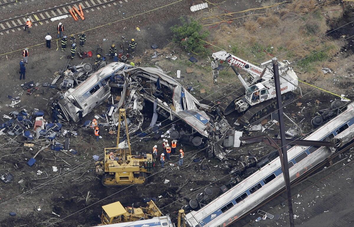 In this aerial photo, emergency personnel work at the scene of a deadly train wreck on May 13 in Philadelphia.
