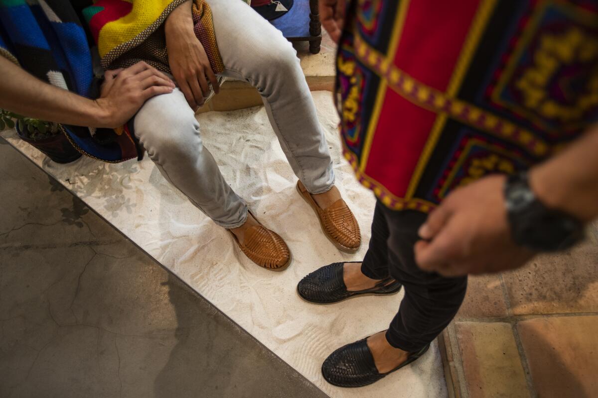The feet of Francisco Alvarez, left, and Oscar Yapor, clad in Mexican huaraches.