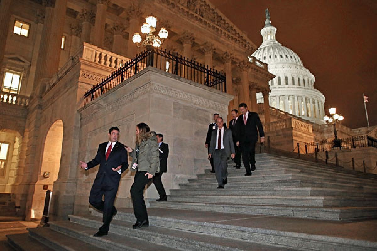 Members of the House of Representatives leave after voting for legislation to avoid the "fiscal cliff" during a rare New Year's Day session January 1, 2013.