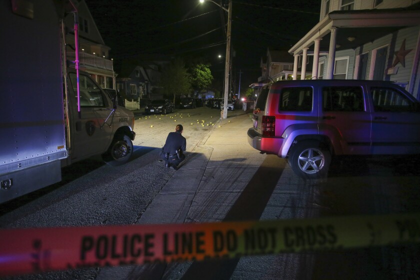 Providence Police investigate a shooting on Carolina Avenue, late Thursday, May 13, 2021, in Providence, R.I. (AP Photo/Stew Milne)