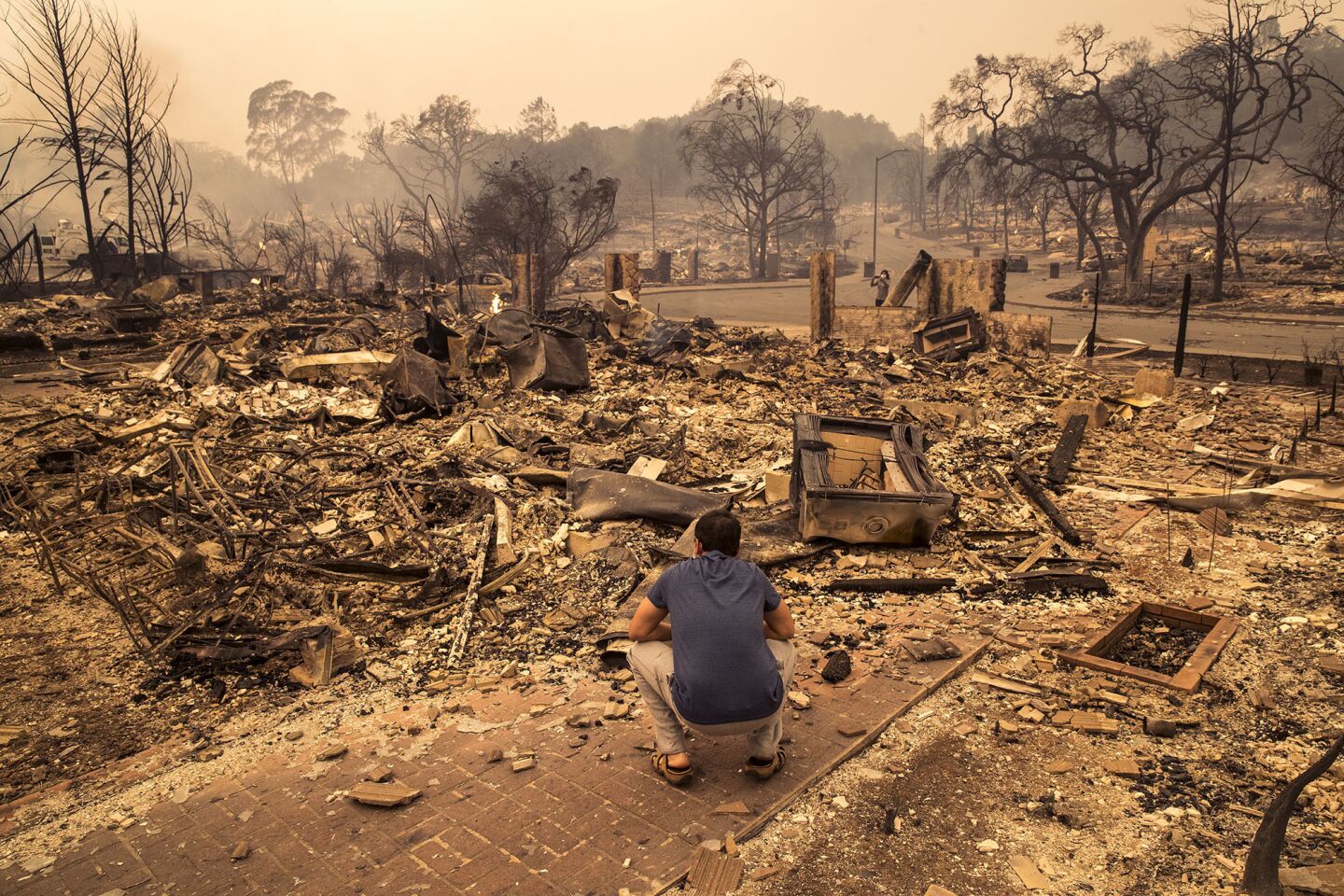 A Fountaingrove Village man surveys the rubble of his home in Santa Rosa.