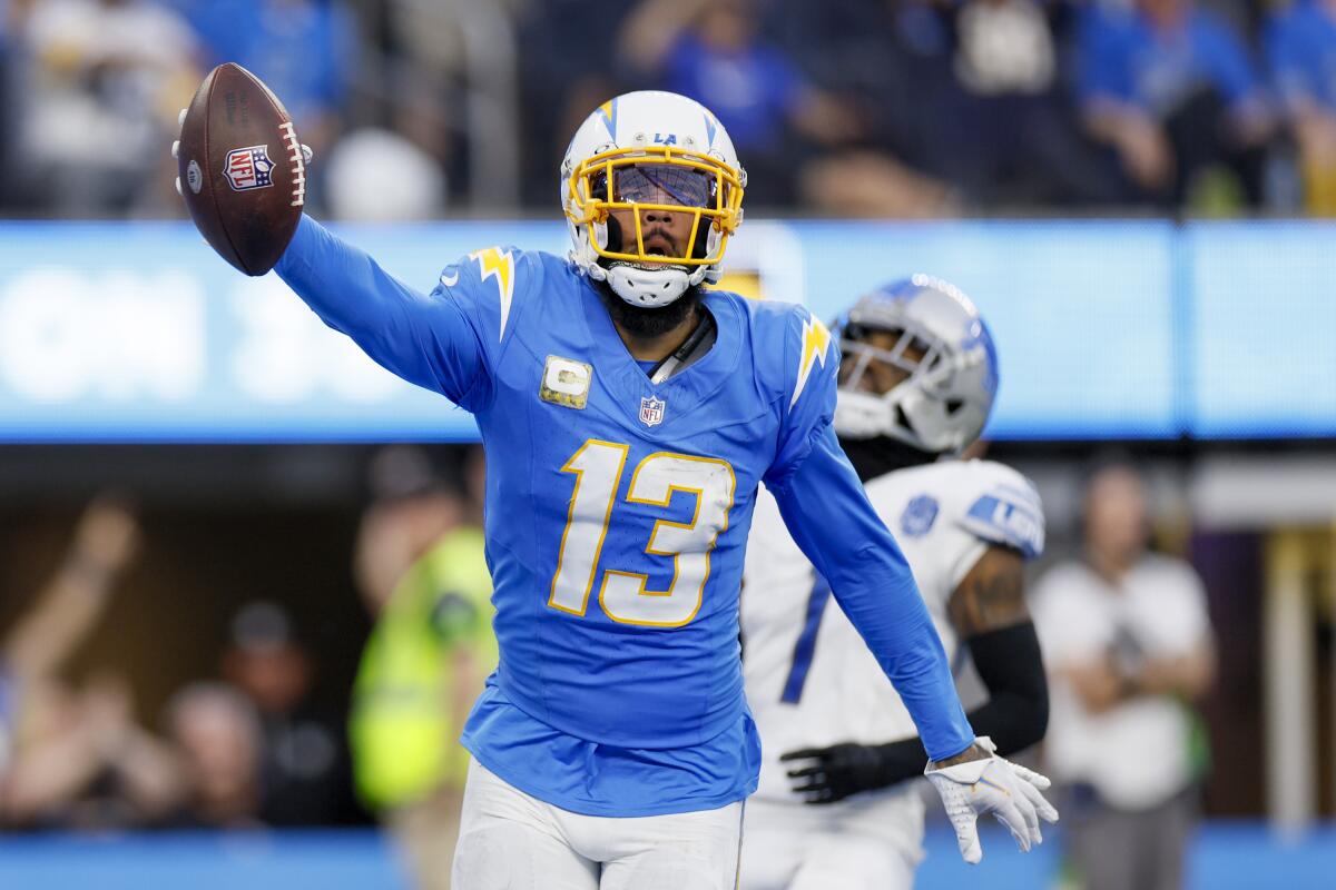 Chargers wide receiver Keenan Allen celebrates his touchdown catch by holding up the football.
