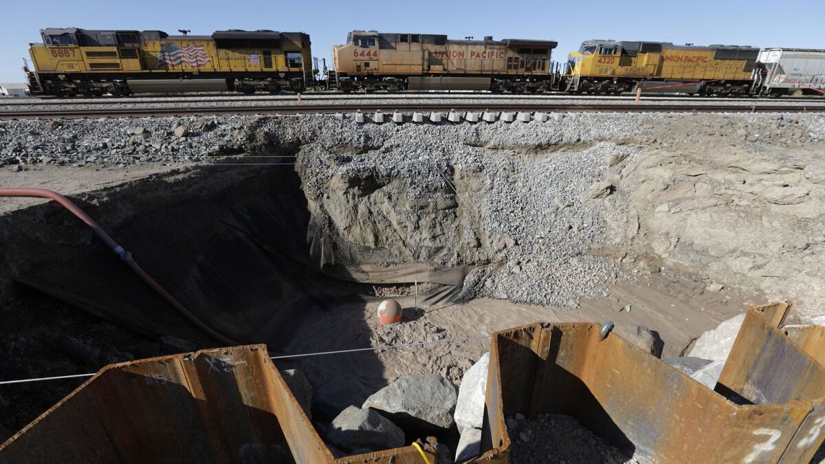 Union Pacific Railroad has already had to move its freight trains to an alternate temporary track because the mud pot has moved so close to the railroad line.