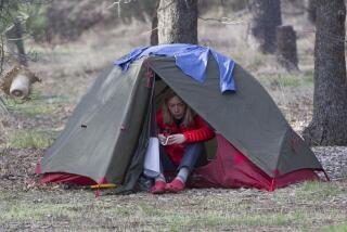 SAN DIEGO, CA.- April 10, 2018,- Carolin Delestrait, from Germany, worked with her GPS device while sitting in her tent at the Burnt Rancheria campground on Mount Laguna where several hikers will usually share the cost of a single campground spot to stay the night. PHOTO/JOHN GIBBINS, Staff photographer, San Diego Union-Tribune) copyright 2018