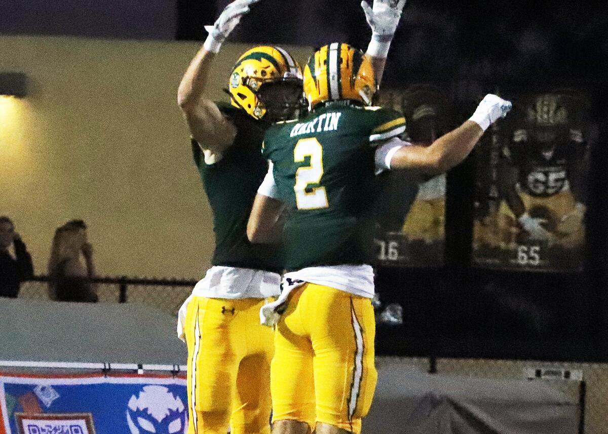 Edison's Mason York (81) and Jacob Martin (2) celebrate the first touchdown of the game against San Clemente.
