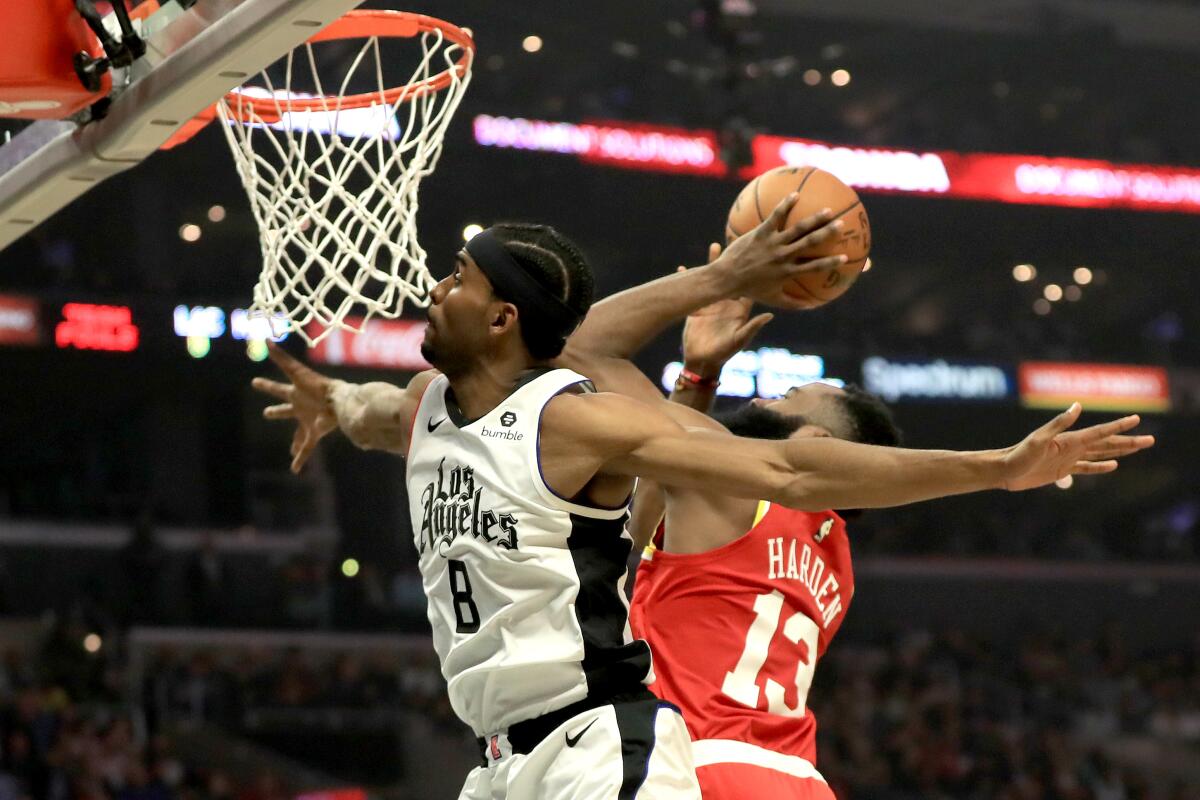 Clippers forward Maurice Harkless defends Rockets guard James Harden during the first half Friday night.