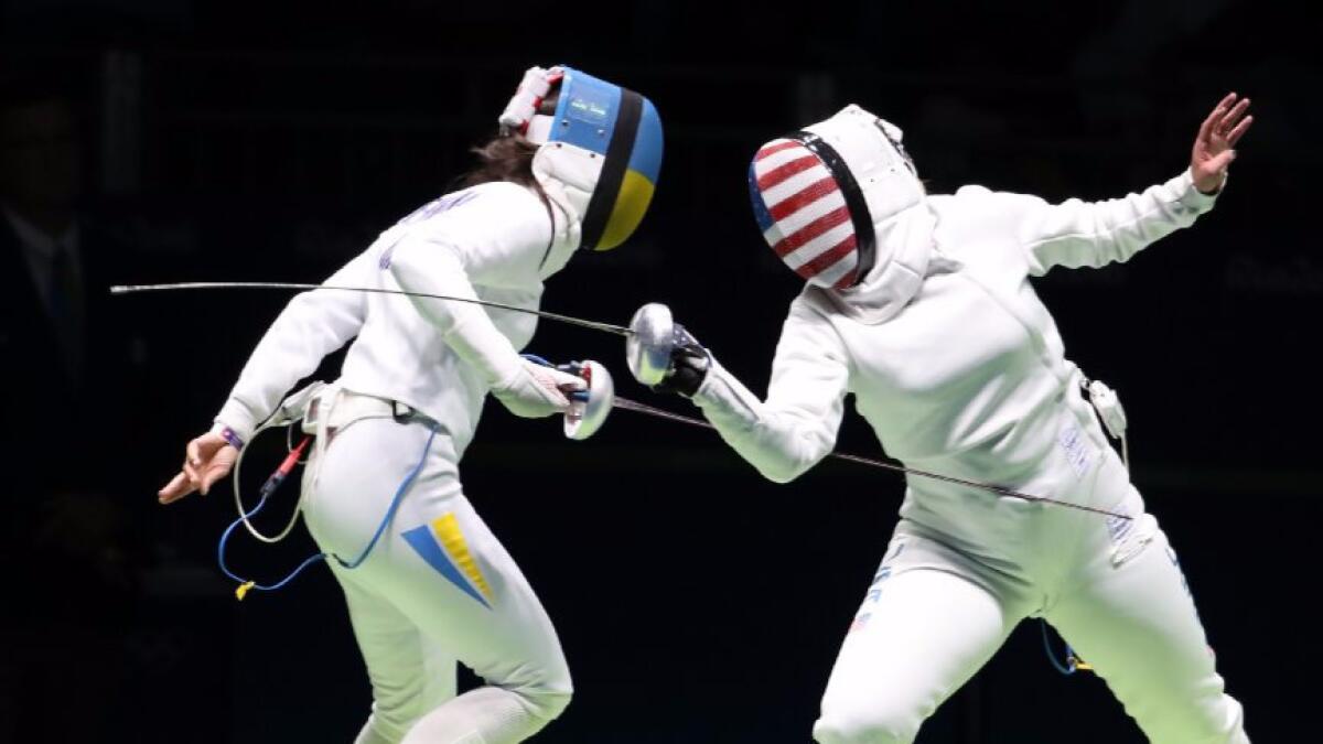 Courtney Hurley of the United States and Yana Shemyakina of Ukraine, left, compete in the women's individual epee event at the 2016 Summer Olympics.