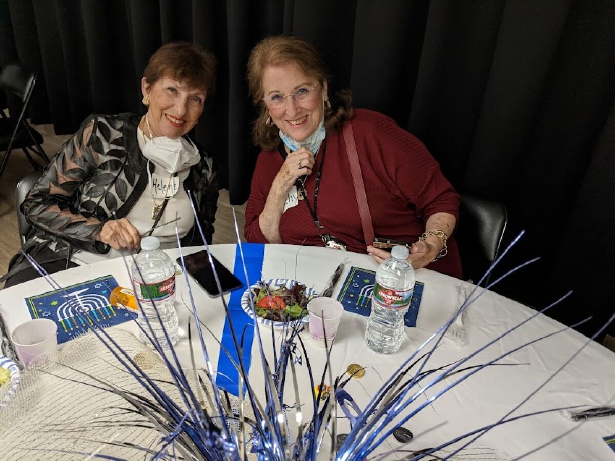 Sisters Helene Baron and Kathy Reibman celebrate Hanukkah at the Lawrence Family Jewish Community Center's Senior Party.