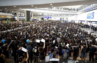 Protesters demonstrate at the airport in Hong Kong on Monday.