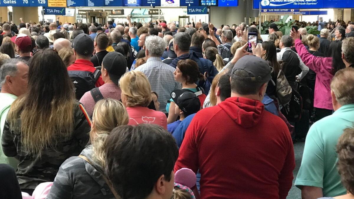 People wait to get through security at the Orlando International Airport following a security incident on Saturday, Feb. 2, 2019.