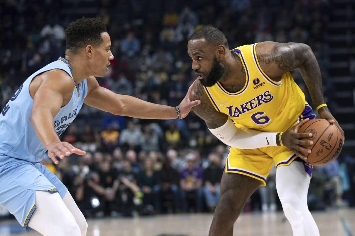Memphis Grizzlies guard Desmond Bane defends against Lakers forward LeBron James.
